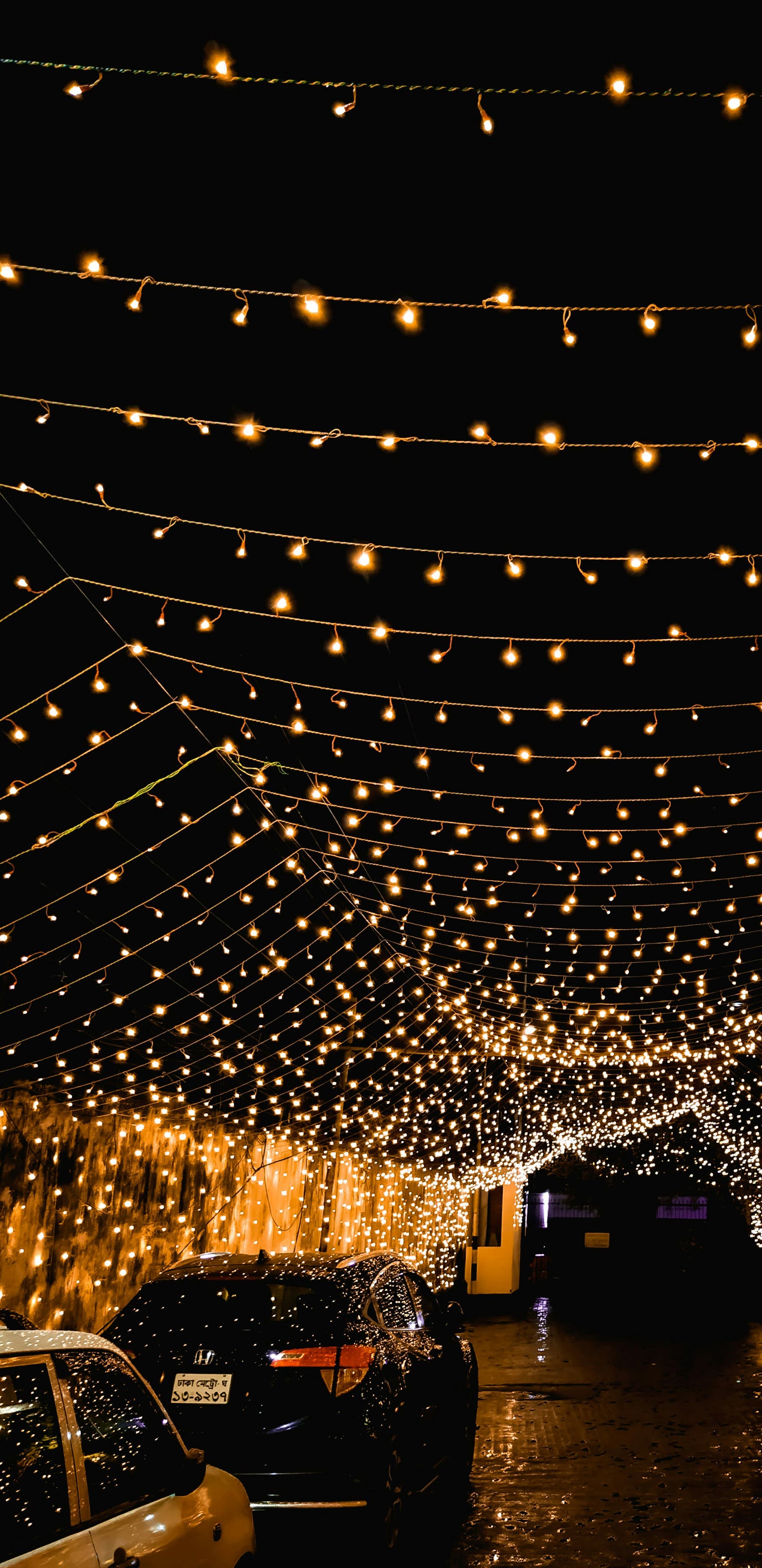 Strings of warm lights across a night sky