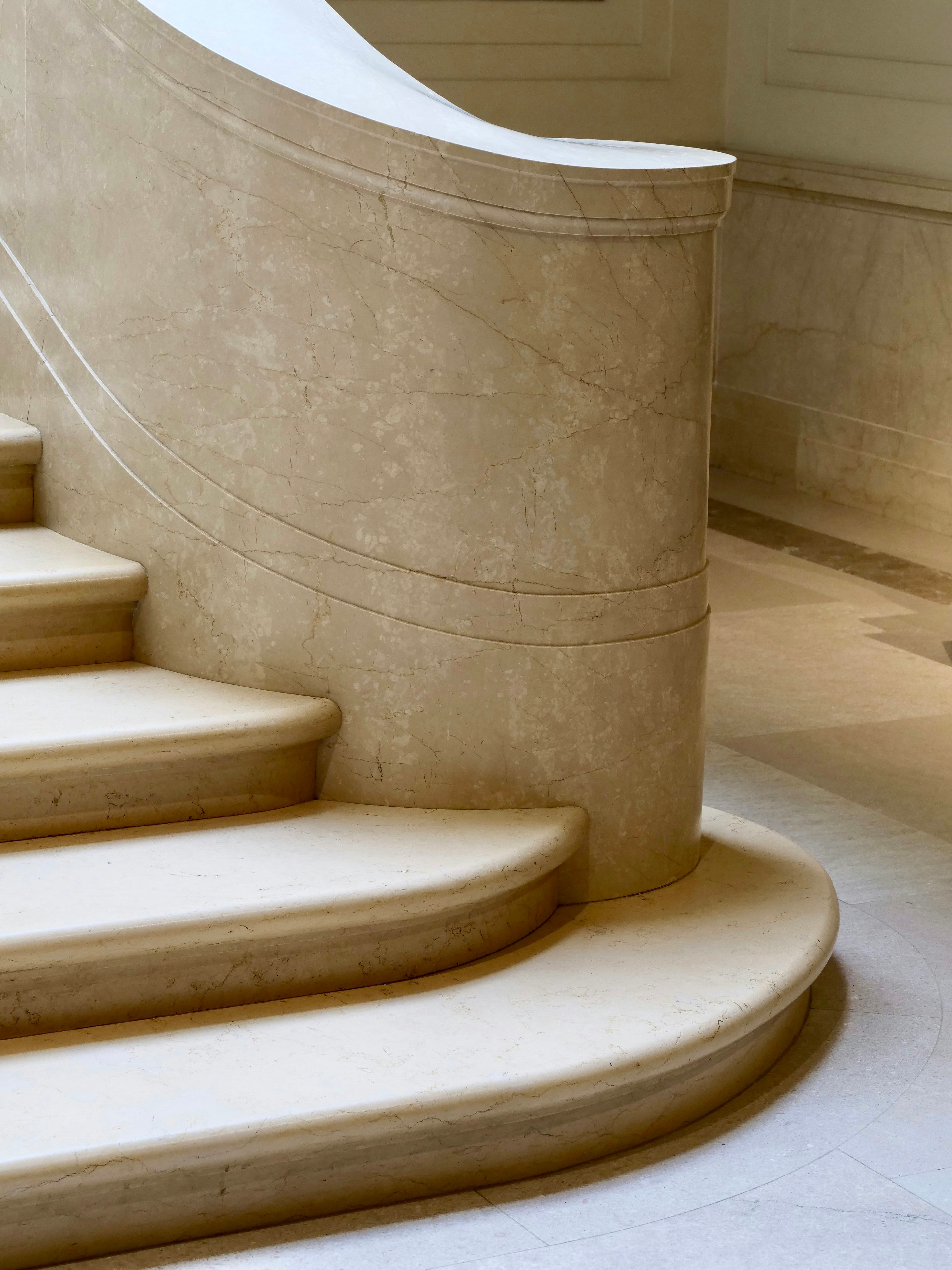 A curved marble staircase in soft light